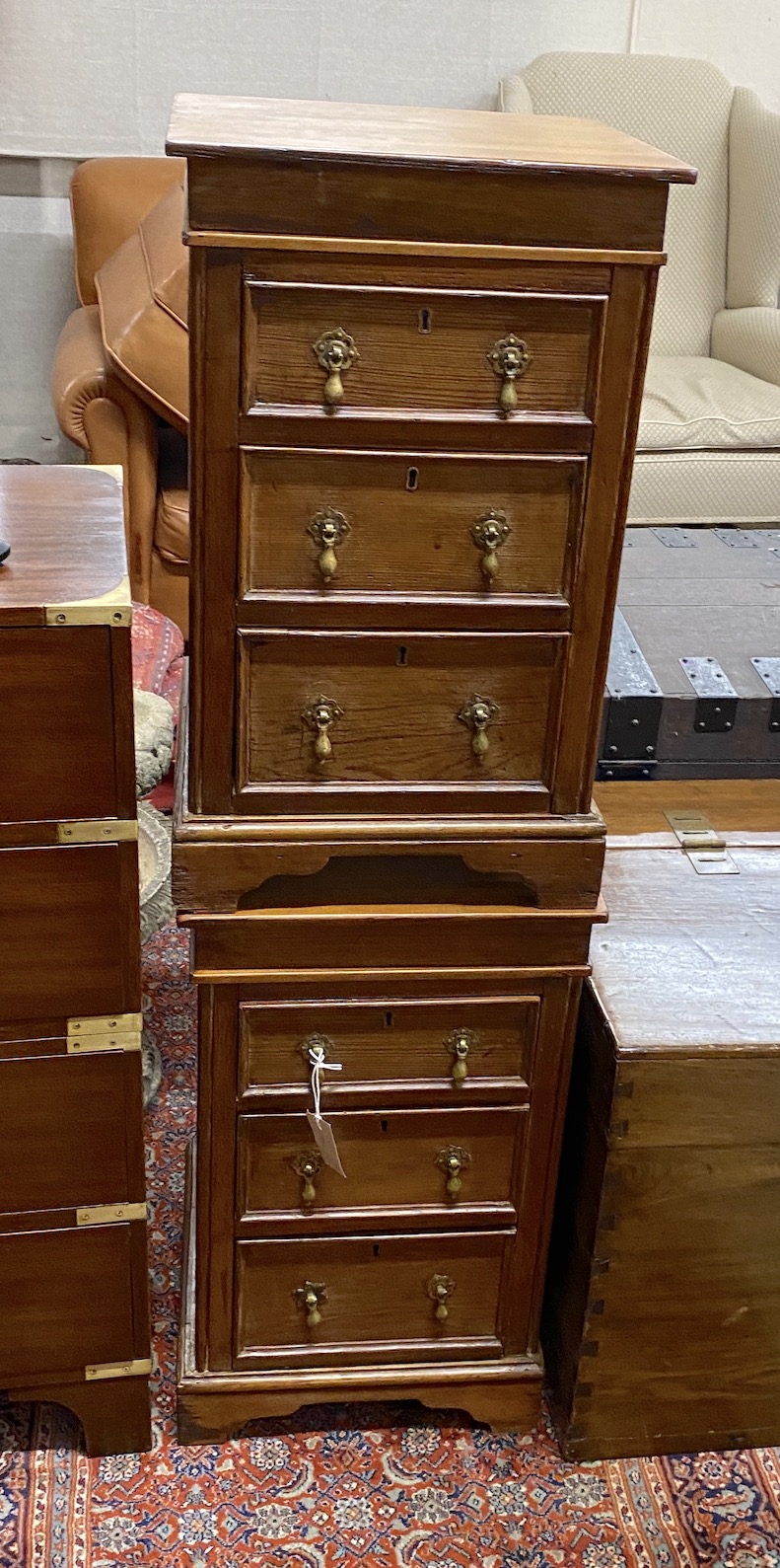 A pair of stained pine three drawer square bedside chests, width 39cm, height 66cm